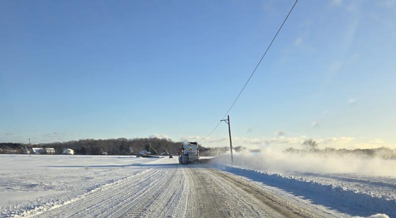 The morning after the recent snowstorm, a state plow does its best to keep the snow from drifting onto Cave Neck Road. CHRIS FLOOD PHOTO